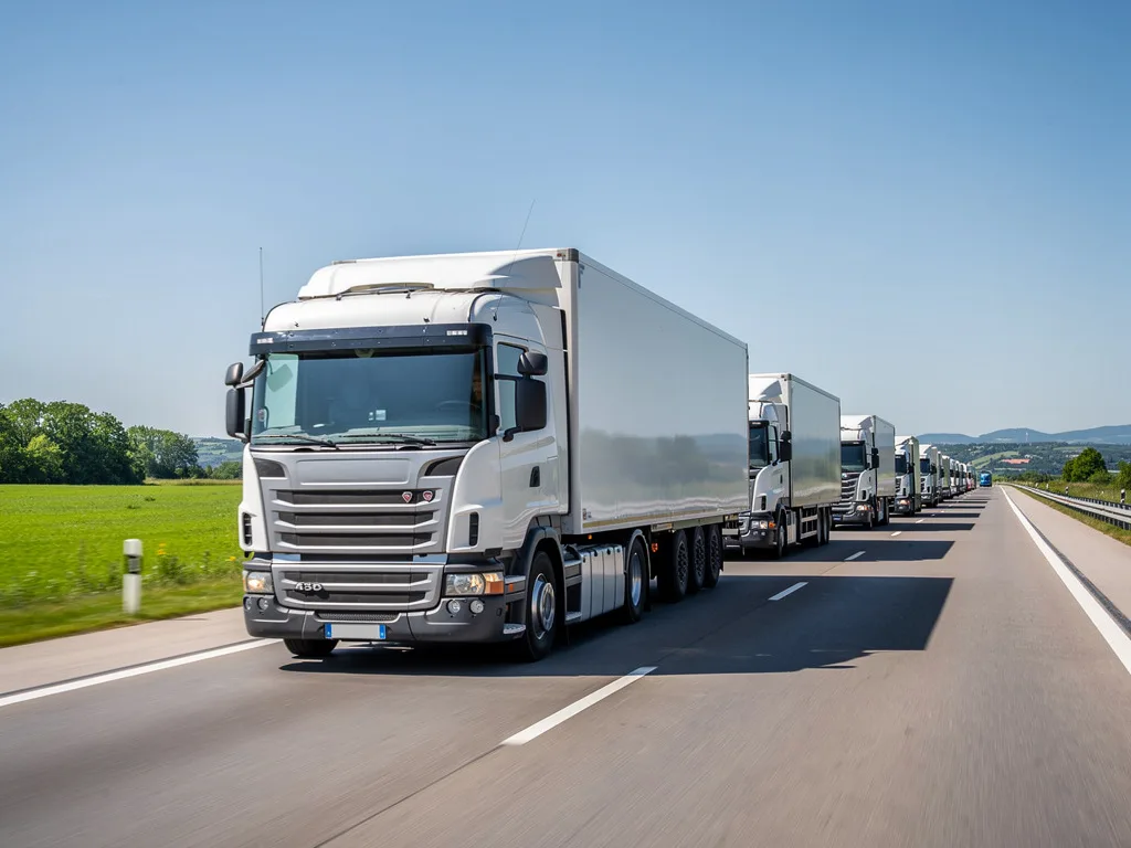 Semi trucks and trailers driving on a highway, transport and logistics fleet